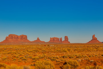 Panoramic pictures of rock formations in the evening sun in the Monument Valley National Park in...
