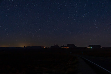 Night scene of rock formation in the Monument Valley National Park with stars in the sky in winter