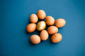 Raw eggs on blue background