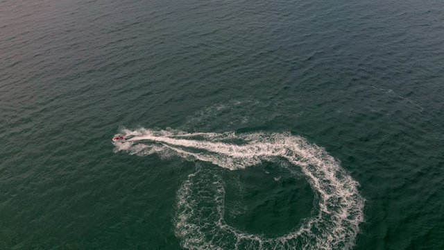 Aerial view of a motor boat sailing near the beach