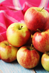 Several ripe red apples on the wooden table