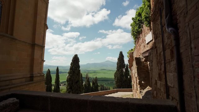 Picturesque view from stone fortress on amazing Tuscan landscapes and cypresses