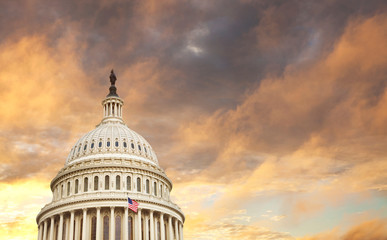 US Capitol dome with American flag and dramatic sky behind © Daniel Thornberg
