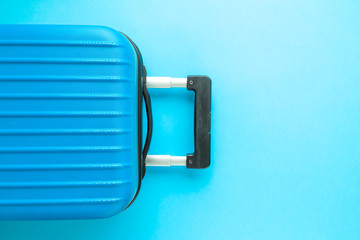 Obraz premium Flat lay of luggage on blue background vacation concept.