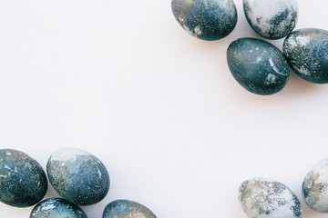 Natural dyed blue colored eggs on white background.