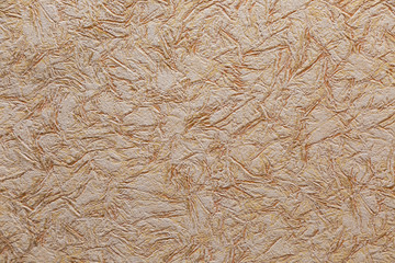 Decorative abstract patterns on the beige wall. Textured background. 