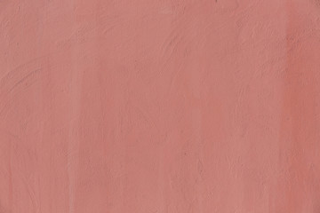 The concrete wall is a pale pink color. Background texture.