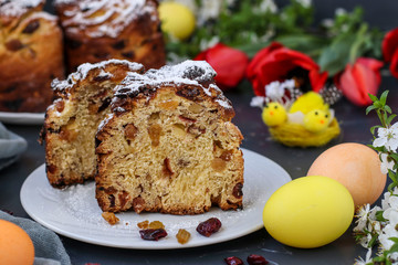 Fototapeta na wymiar Easter cake Cruffin and colorful eggs on a dark background, The concept of the spring orthodox church holiday, Horizontal orientation