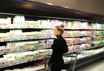 Woman choosing a dairy products at supermarket	