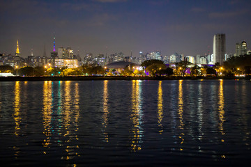 Fototapeta na wymiar Sao Paulo, Brazil, August 13, 2013. Night view lake in Ibirapuera Park and Sky line of city in Sao Paulo