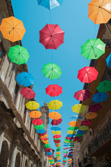 Fototapeta na wymiar Licata street decorated with umbrella. Sicily, Italy