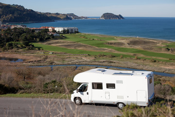 Recreation Vehicle Concept. Camper van on the road in Euskadi sea coast.