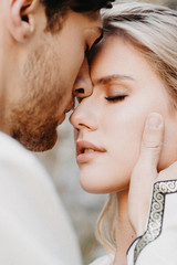 noise effect, selective focus: Emotional meeting, hugs and kisses on brides during wedding photography. Stylish couple of husband and wife