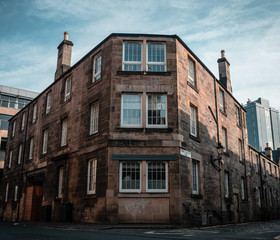 Old brick apartment building on a street corner in Edinburgh, Scotland