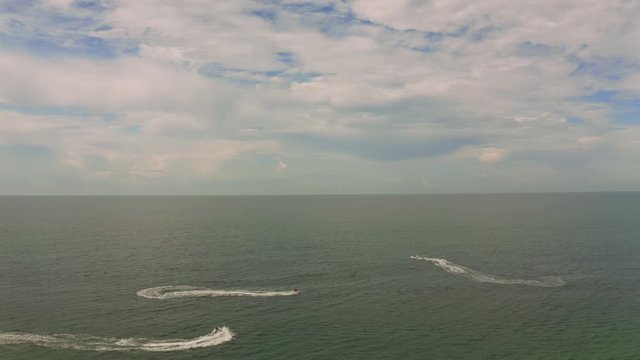 Aerial view of a motor boat sailing near the beach