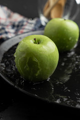 Photography of Verdews apples in black and water background
