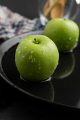 Photography of Verdews apples in black and water background
