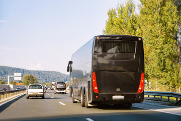 Black Tourist bus in the road in Poland. Travel concept.
