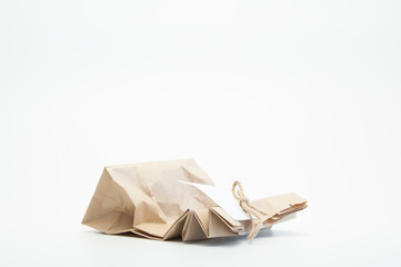 Gift paper parchment bag with bow and note. On white background