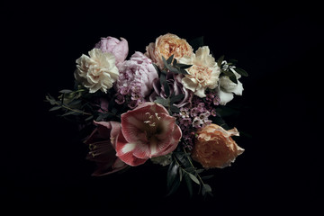 Beautiful bouquet of different flowers on black background. Floral card design with dark vintage...