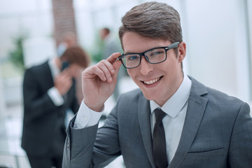 responsible business man looking through his glasses.