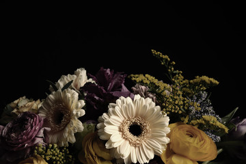 Beautiful bouquet of different flowers on black background. Floral card design with dark vintage effect