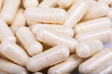 Transparent gelatine capsules with powder, close up view. Pharmaceutical concept. Medical background