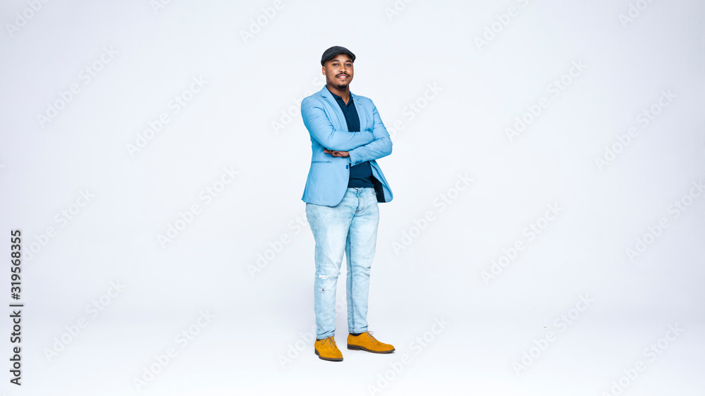 Wall mural businessman in cap standing with his arms crossed