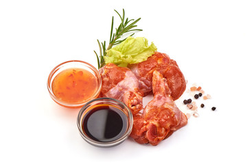 Raw chicken legs in a barbecue marinade, isolated on white background