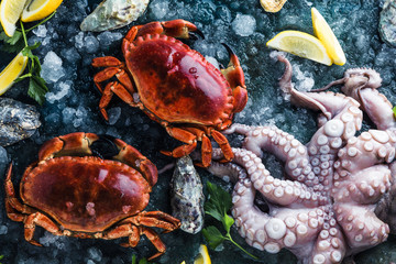 Assortment of seafood with raw fresh octopus gourmet dinner background, oysters and with red edible crab
