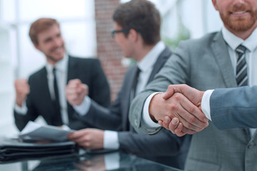 business people shaking hands during a business meeting .