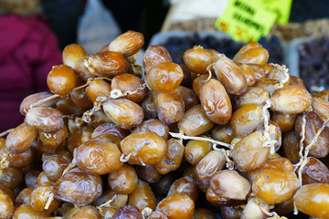 a large amount of fresh fresh dates, palm fruit sold in the shop,