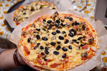 Overhead shot of friends at a table sharing take-away pizzas