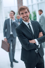 Fototapeta na wymiar smiling business man standing in a modern office