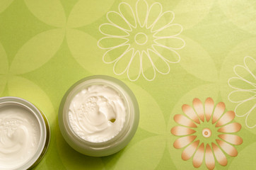 Jar of cream for face and body plant wooden background. Natural cosmetics for face and body skin care, organic beauty. top view, light light green background.