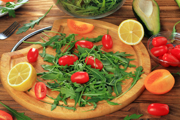 Arugula salad on a wooden table.