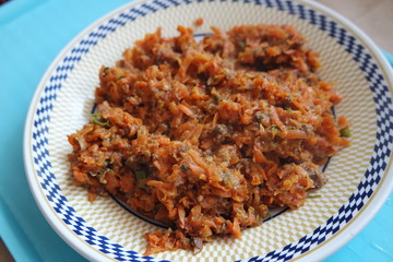 Top closeup view of a homemade dish made from carrot and vegetables.