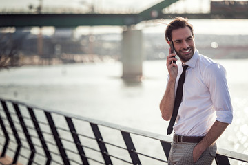 Business man having a conversation on his cell phone outdoors