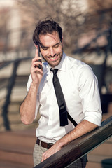 Business man having a conversation on his cell phone outdoors