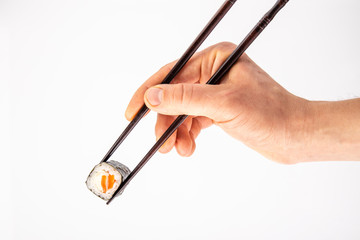 roll between chopsticks for sushi on a light background for the menu6