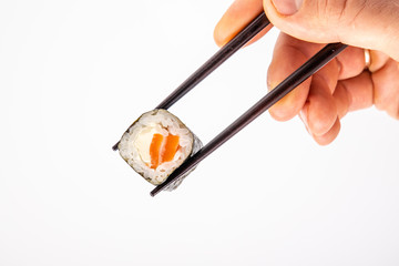 roll between chopsticks for sushi on a light background for the menu7