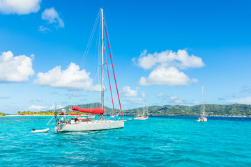 Turquoise sea and anchored yachts near Carriacou island, Grenada, Caribbean sea - obrazy, fototapety, plakaty