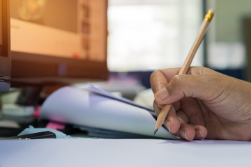Business man manager holding pencil for checking and signing applicant filling documents reports papers company application form or registering claim on desk office
