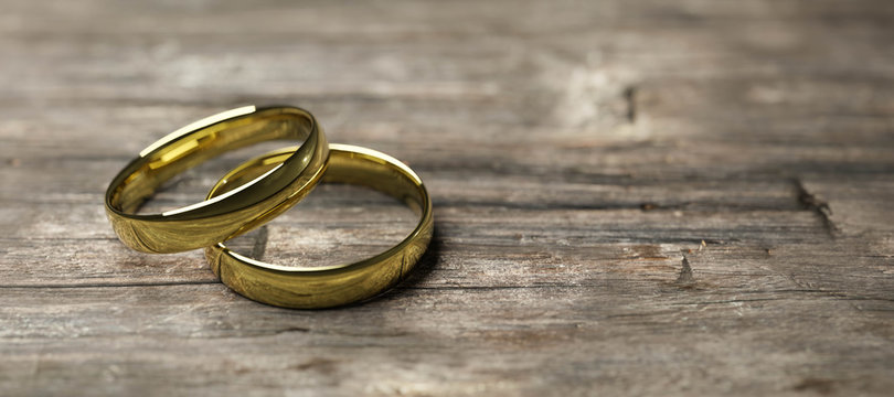gold wedding rings on wooden table soft focus macro shot 3d render illustration