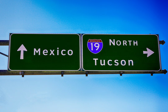 Overhead traffic signs pointing to Mexico and to I-19 to Tucson in Nogales AZ