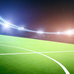 Football field on a stadium with lights and flashes at night