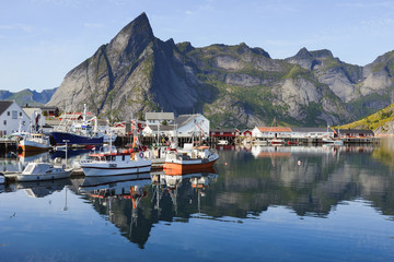 Norwegian fishing village at the Lofoten Islands in Norway. Colorful boats in the foreground.