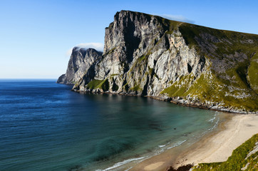 Ocean Coast during a vibrant summer sunset. Taken in Kvalvika beach, Lofoten Island, Norway