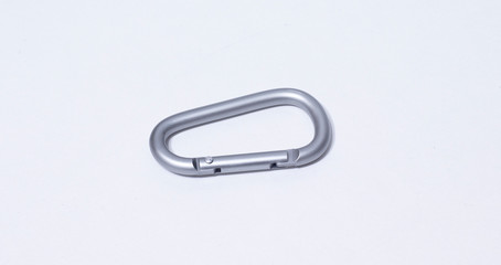 Gray carbine on white background. It is a safety equipment for climbing and mountaineering.