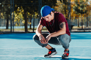 Tattooed man portrait, looking to camera. B boy posing
